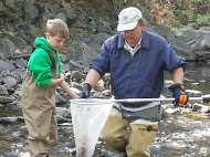 Toby Smith fishes in a stream with club member Ben Werchowsky